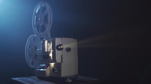 Vintage Film Projector Showing Movie in Dark Room