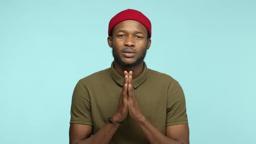 Man Puts Hands Together While Speaking Seriously