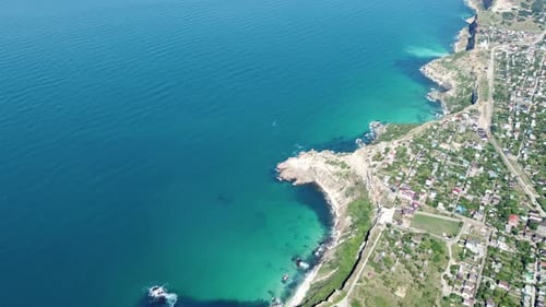 Aerial View From Above on Calm Azure Sea and Volcanic Rocky Shores