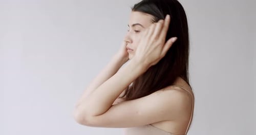 Elegant Woman Touching Her Face and Neck