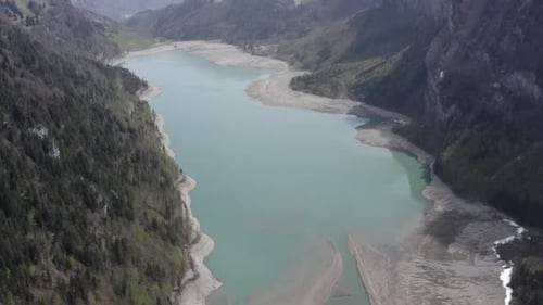 Drone view of a decreased lake in the Swiss Alps