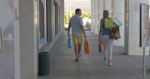 Young people leaving trade centre being happy with shopping