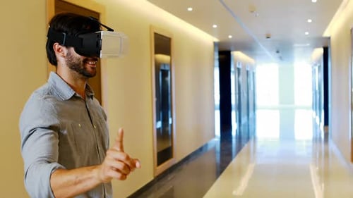 Man Experiencing Virtual Reality Headset in Modern Hallway