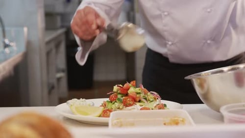 Chef Plates Fish Dish With Colorful Salad