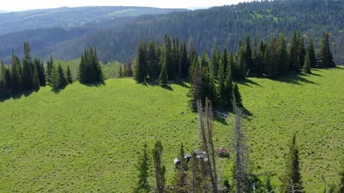 Orbiting aerial view of a camp site in the high Uinta Mountains with stunning scenery all around