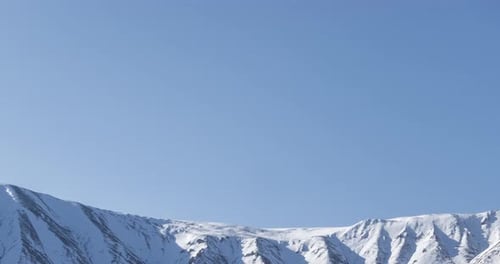 Timelapse of Sun Movement on Crystal Clear Sky Over Snow Mountain Top