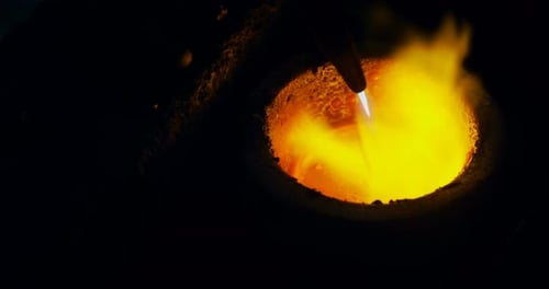 Tool Working in Dark, Fiery Industrial Environment