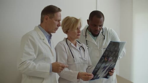 Doctors Reviewing Brain Scan in Hospital Setting