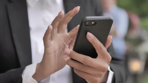 Close Up of Hands Using Mobile Phone