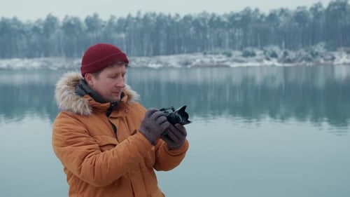 Hiker Taking Pictures of Snowy Nature in Winter Lake Background Winter Forest