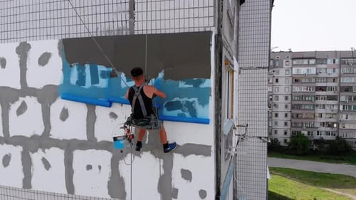 Aerial, Industrial Climber für isolierte Fassaden Kittzement auf Fiberglas-Netz