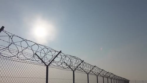Barbed Wire Fence Against Sky