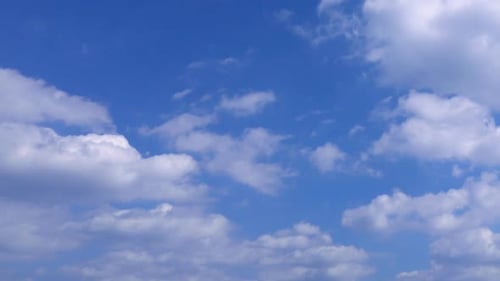 Fluffy Clouds in Bright Blue Summer Sky