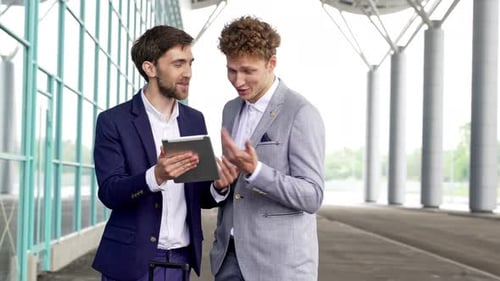 Two Business Partners Businessmans Standing Near Factory Enterprise or Airport Looking at Digital
