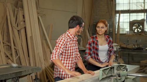 Man and Woman Working Wood at Machine
