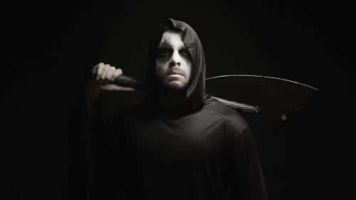 Grim Reaper Over Black Background with Axe in His Hands