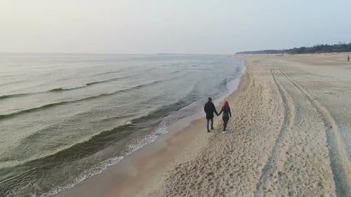 Happy Couple Walking on the Beach