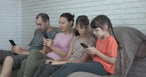 Family on Couch Uses Phones