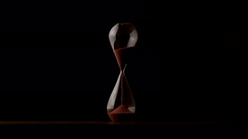 Hourglass with Red Sand on Black Background