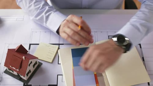 Architect Reviews Blueprints in the Office