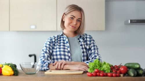 Woman in Kitchen with Fresh Vegetables