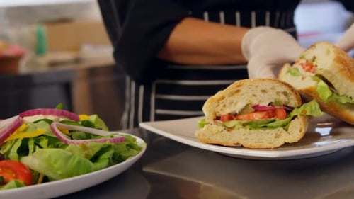 Chef Prepares Sandwich with Salad in Restaurant Kitchen
