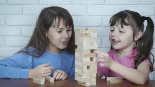 Children play with wooden blocks.