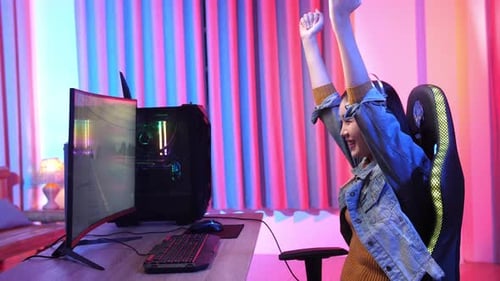 Young Woman Plays Video Game and Celebrates