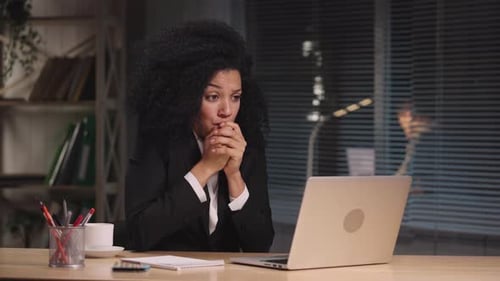 Worried Woman Working Late on Laptop