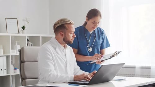 Professional medical doctors working in hospital office. Physician and the young nurse.