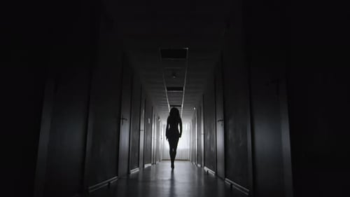 Lonely Woman Walking in the Darkness
