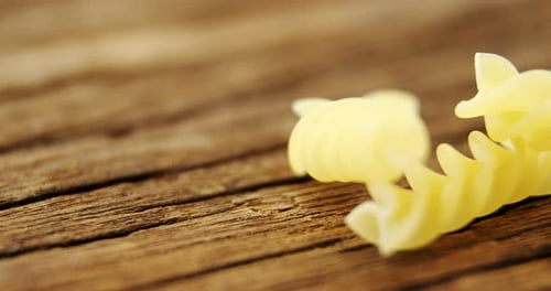 Gemelli pasta on wooden table