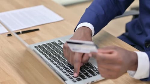 Online Shopping on Laptop By African Businessman