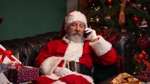 Santa Claus Talking on Phone by Christmas Tree