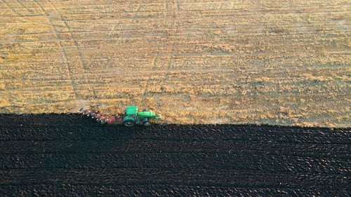 Aerial View of a Tractor Plowing Agricultural Farm Field