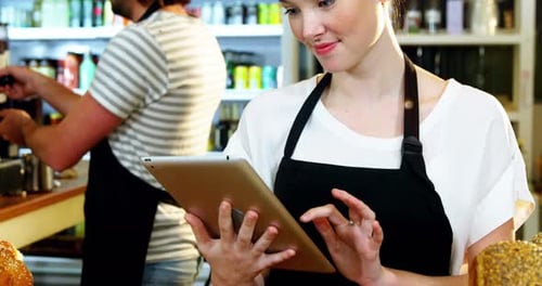 Cafe Workers Using Tablet and Making Coffee