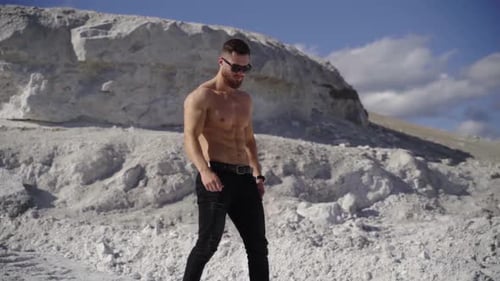 Muscular Man Posing Shirtless in a White Landscape