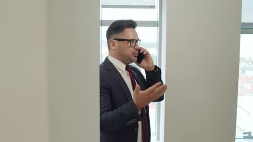 Professional Man Talking on Cell Phone in Office
