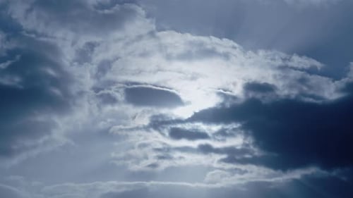 Dramatic Sunbeams Bursting Through Gray and White Clouds