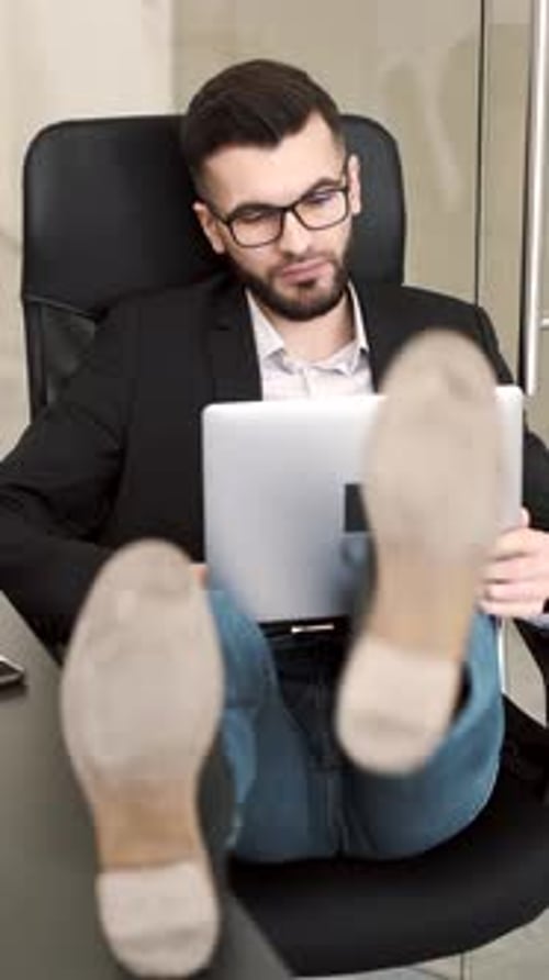 Laidback Businessman Working with His Feet Up
