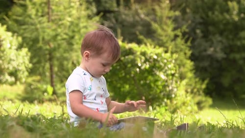Happy Boy Playing in Tablet Outdoors