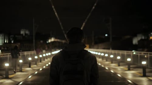 Rear View at a Lonely Man in Hood Standing His Back Outside Walking Down Empty Street Homeless