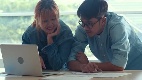 Young Adults Review Data at Workplace