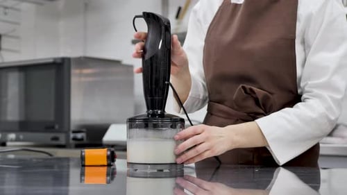 Chef Blending Food Ingredients in Professional Kitchen