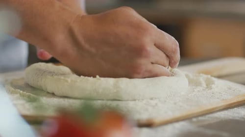 Close up of hands preparing fresh pizza dough