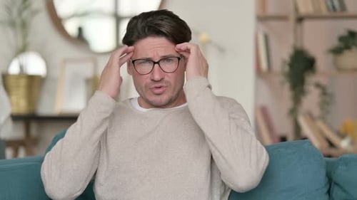 Middle Aged Man Having Headache at Home
