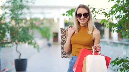Young happy blonde Attractive woman spending leisure time at big modern mall.