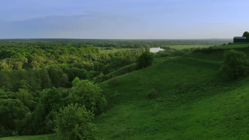 Aerial View of Green Summer Forest and Canyon at Sunset