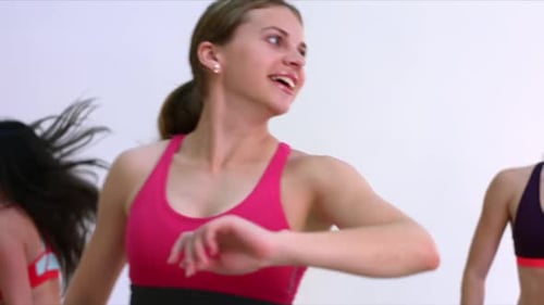 Smiling Women Exercising Together in Fitness Class