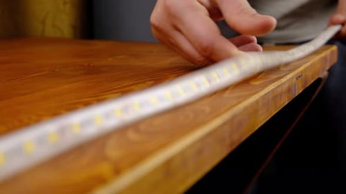 LED Lights Adhered to Edge of Wooden Table